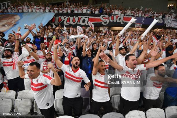 Zamalek fans cheer their team from the stands ahead of the Egyptian Super Cup football match between Zamalek and Al-Ahly at the Hazza bin Zayed...