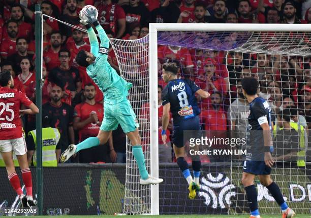 Ahly's Egyptian goalkeeper Mohamed el-Shenawy saves the ball during the Egyptian Super Cup football match between Zamalek and Al-Ahly at the Hazza...