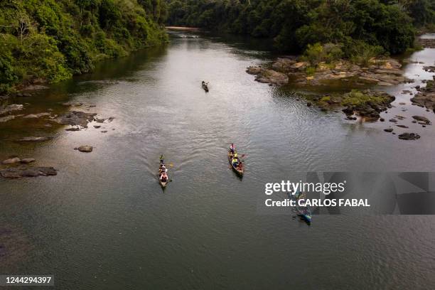 Indigenous people, riverside population, scientific researchers and journalists cross the Volta Grande of the Xingu River in canoes during a mission...