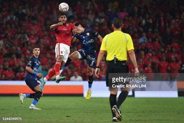 Ahly's Egyptian forward Shady Hussein and Zamalek's Egyptian midfielder Emam Ashour vie for a header during the Egyptian Super Cup football match...