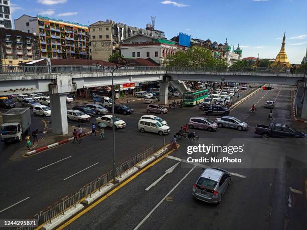 Cars and buses drive on Sule Pagoda road in Yangon, Myanmar on October 28, 2022.