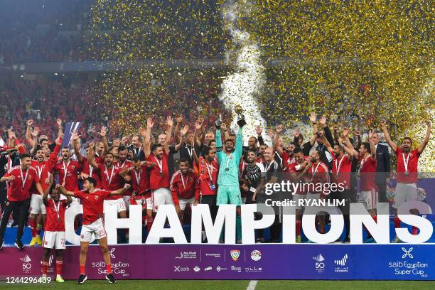 Ahly's players celebrate with the trophy of the Egyptian Super Cup after winning over Zamalek at the Hazza bin Zayed stadium in al-Ain on October 28,...