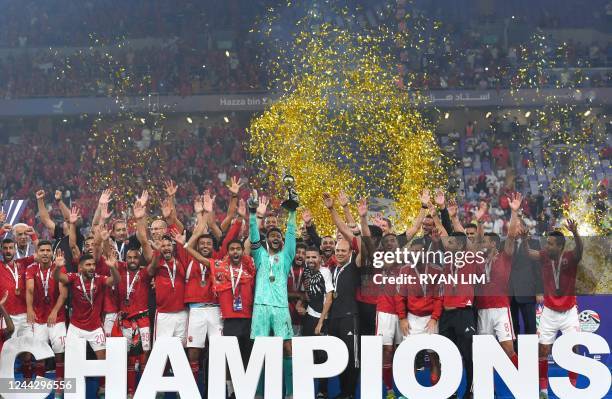 Ahly's players celebrate with the trophy of the Egyptian Super Cup after winning over Zamalek at the Hazza bin Zayed stadium in al-Ain on October 28,...