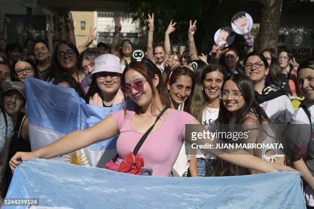 Fans of the South Korean band BTS pose as they queue to access to River Plate's Monumental stadium to attend the fourth of ten concerts of the...