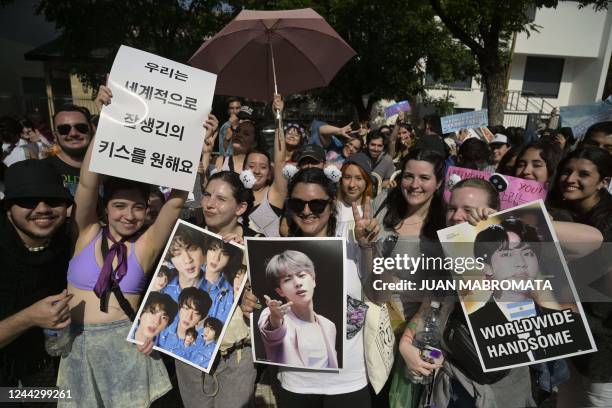 Fans of the South Korean band BTS pose as they queue to access to River Plate's Monumental stadium to attend the fourth of ten concerts of the...