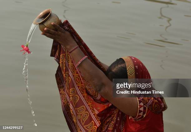Devotee offers prayers in Yamuna river ahead of Chhath Puja on October 28, 2022 in Noida, India. The four-day celebrations of Chhath Puja began on...