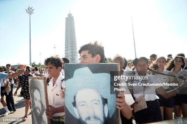 Cuban students carry an image of late revolution commander Camilo Cienfuegos during a march on the occasion of the 63rd anniversary of Cienfuegos'...