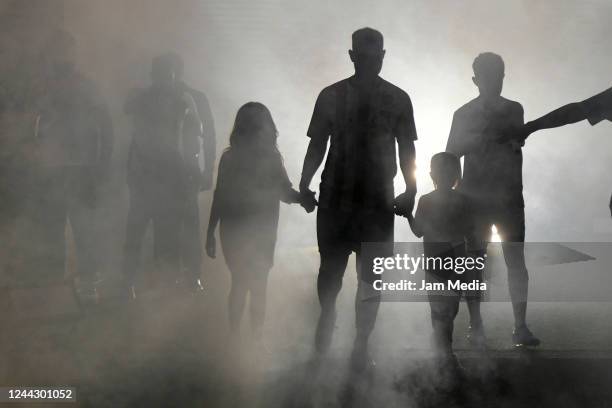 Former soccer player Gaston Fernandez walks towards the pitch with his children prior a farewell match for Gaston 'Gata' Fernandez at Jorge Luis...