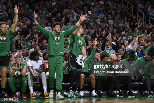 The Boston Celtics bench celebrates a three point basket during the game against the Cleveland Cavaliers on October 28, 2022 at the TD Garden in...