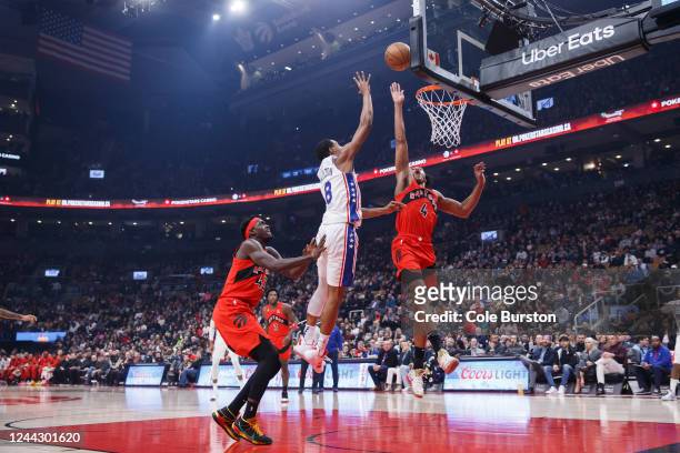 Scottie Barnes of the Toronto Raptors tries to block a shot by Shake Milton of the Philadelphia 76ers during the first half of the game against the...