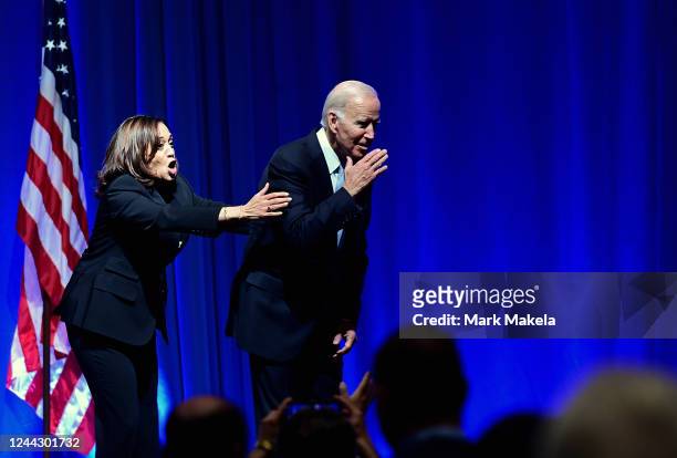 President Joe Biden and US Vice President Kamala Harris react while greeting supporters during the Democratic Party's Independence Dinner on October...