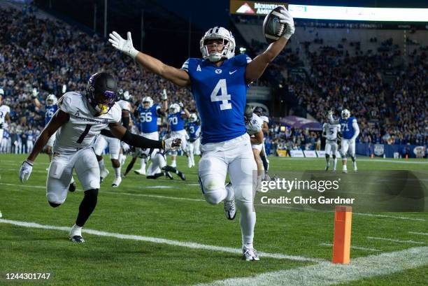 Lopini Katoa of the Brigham Young Cougars scores a touchdown against Malik Fleming of the East Carolina Pirates during the first half of their game...