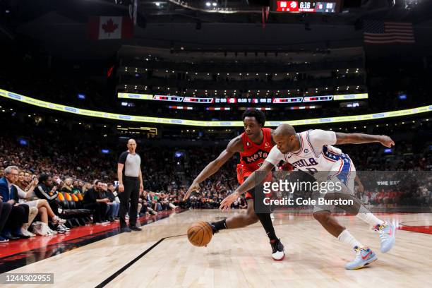 Anunoby of the Toronto Raptors and P.J. Tucker of the Philadelphia 76ers chase down a ball during the second half of their NBA game at Scotiabank...