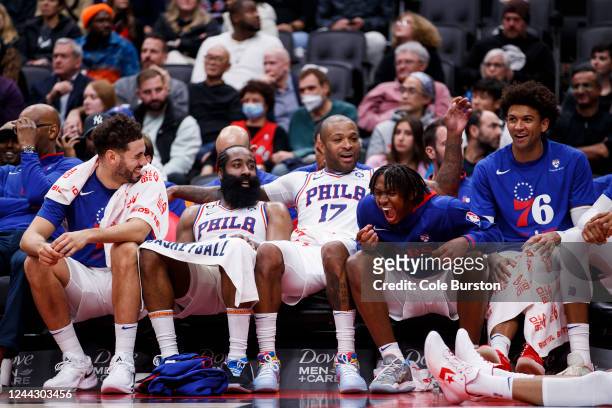 Tyrese Maxey of the Philadelphia 76ers laughs on the bench alongside Georges Niang, James Harden, P.J. Tucker, and Matisse Thybulle during the second...