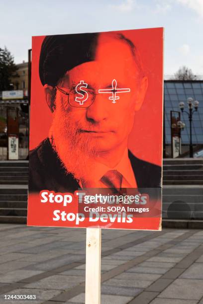 Placard with a portrait composed of the faces of Vladimir Putin and Ali Khamenei and the symbols of the dollar and the drone and the inscription Stop...