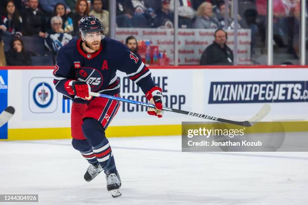 Adam Lowry of the Winnipeg Jets skates during second period action against the St. Louis Blues at Canada Life Centre on October 24, 2022 in Winnipeg,...