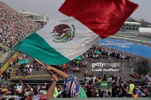 Person waves the Mexican flag during the second practice session of the Mexico City Grand Prix at the Autódromo Hermanos Rodríguez, which will be...