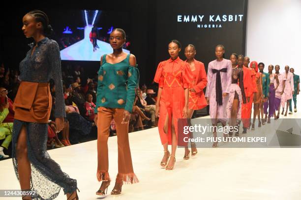 Models walks the runway to show designs by Emmy Kasbit during the Lagos Fashion Week in Lagos on October 28, 2022. - Lagos Fashion Week is held...