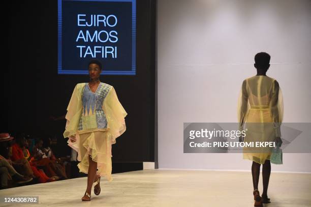 Models walk the runway to show designs by Ejiro Amos Tafiri during the Lagos Fashion Week in Lagos on October 28, 2022. - Lagos Fashion Week is held...