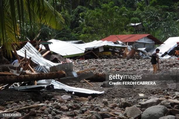 Resident walks past a destroyed house in the landslide-hit village of Kusiong in Datu Odin Sinsuat in the southern Philippines' Maguindanao province...