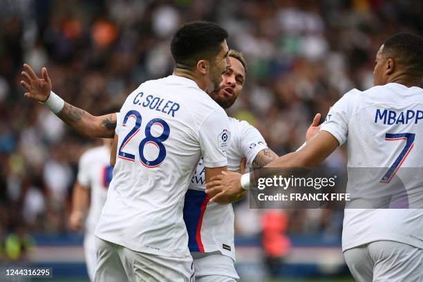 Paris Saint-Germain's Spanish midfielder Carlos Soler celebrates with Paris Saint-Germain's Brazilian forward Neymar and Paris Saint-Germain's French...