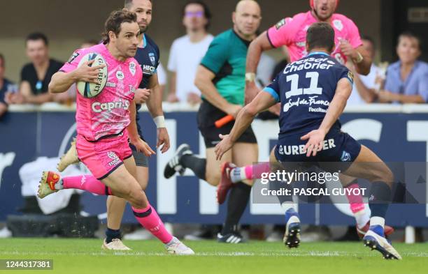 Stade Francais' Argentinian fly-half Nicolas Sanchez runs to evade Montpellier's French wing Vincent Rattez during the French Top 14 rugby union...