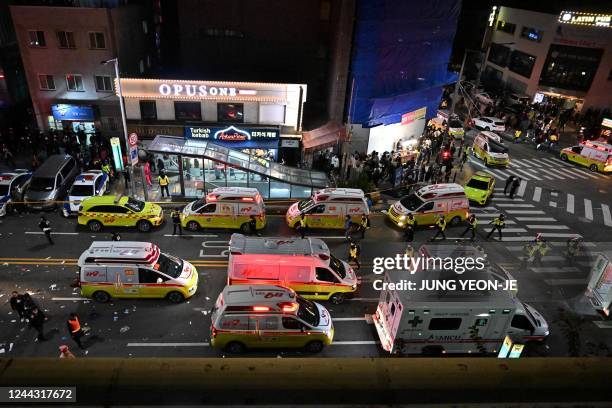 Ambulances arrive on the scene where dozens of people suffered cardiac arrest in the popular nightlife district of Itaewon in Seoul on October 30,...