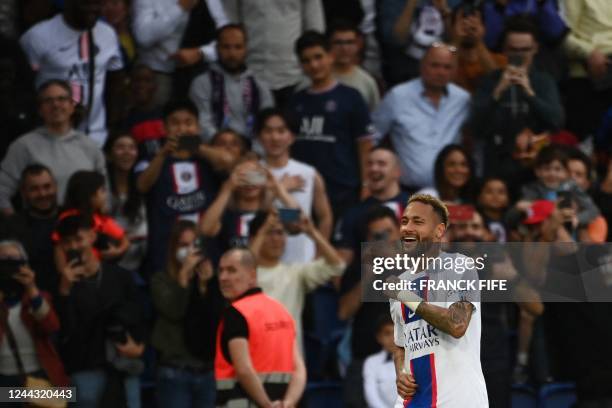 Paris Saint-Germain's Brazilian forward Neymar celebrates scoring his team's third goal during the French L1 football match between Paris...