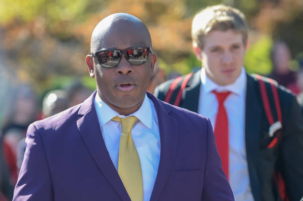 Interim head coach Mickey Joseph of the Nebraska Cornhuskers leads the team on the walk to the stadium before the game Illinois Fighting Illini at...