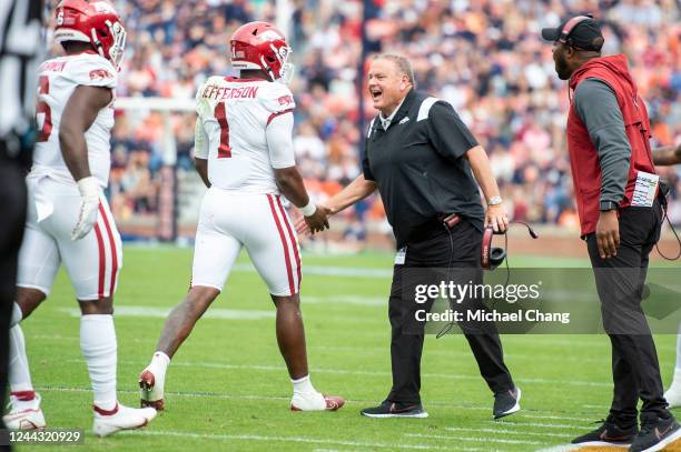 Quarterback KJ Jefferson of the Arkansas Razorbacks celebrates with head coach Sam Pittman of the Arkansas Razorbacks after scoring a touchdown...