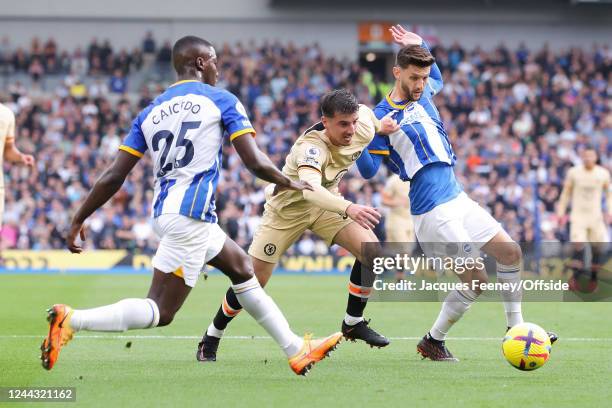 Mason Mount of Chelsea is put under pressure by Moises Caicedo of Brighton & Hove Albion and Adam Lallana of Brighton & Hove Albion during the...