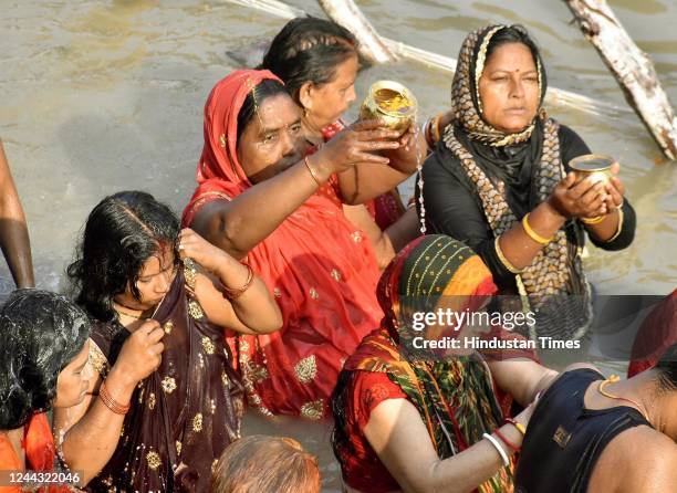 Devotees take a dip in the Ganga River on the occasion of Kharna Pooja as part of the Chhath Pooja festival at Gandhi Ghat, on October 29, 2022 in...