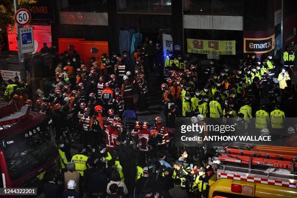 Rescue officials and police gather in the district of Itaewon in Seoul on October 30 after a Halloween crush which left at least 120 people dead. -...
