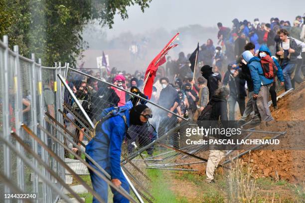 Activists take down fences of the construction site of a new water reserve for agricultural irrigation, during a demonstration called by the...