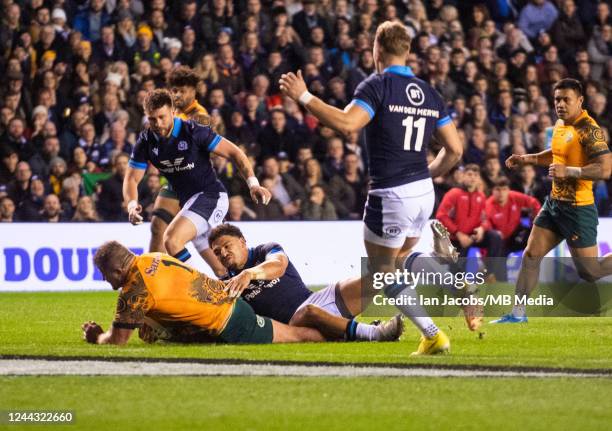 Australian Prop, James Slipper, powers his way through the home defence to make the score 15-13 to the Scots during the Autumn International match...