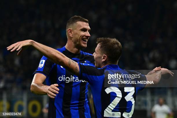 Inter Milan's Italian midfielder Nicolo Barella is congratulated by Inter Milan's Bosnian forward Edin Dzeko after scoring his team's second goal...