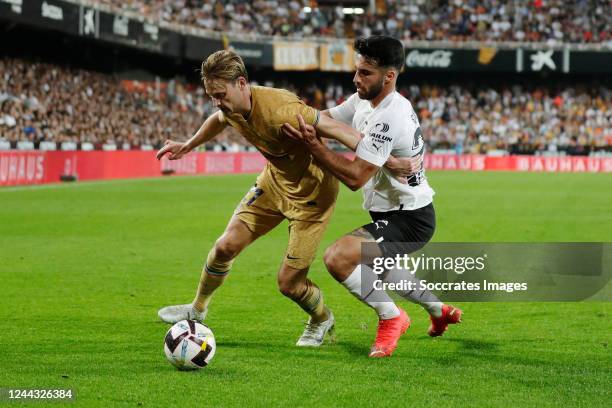 Frenkie de Jong of FC Barcelona, Eray Comert of Valencia during the La Liga Santander match between Valencia v FC Barcelona at the Estadio de...