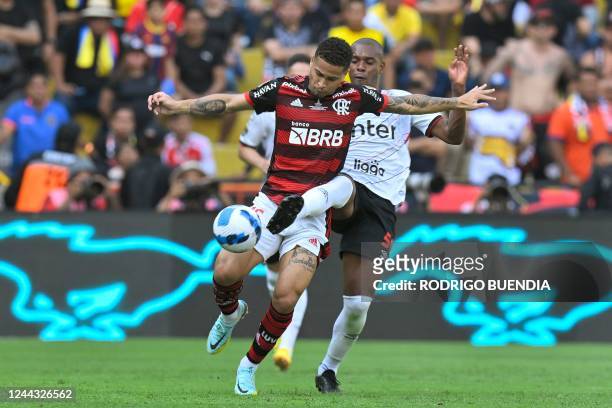Flamengo's Brazilian midfielder Joao Gomes and Athletico Paranaense's Brazilian midfielder Fernandinho vie for the ball during the Copa Libertadores...