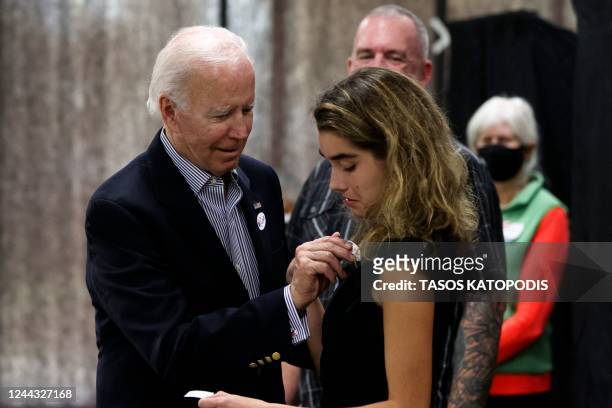 President Joe Biden placed an 'voted' sticker on granddaughter Natalie Biden after they voted early, in Wilmington, Delaware on October 29, 2022. -...