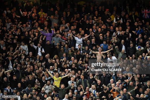 Leeds fans celebrate after the final whistle of the English Premier League football match between Liverpool and Leeds United at Anfield in Liverpool,...