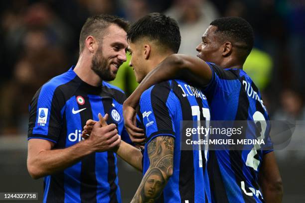 Inter Milan's Argentinian forward Joaquin Correa is congratulated by Inter Milan's Dutch defender Stefan de Vrij and Inter Milan's Dutch midfielder...