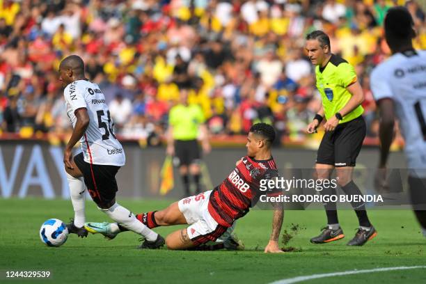 Athletico Paranaense's Brazilian midfielder Fernandinho is marked by Flamengo's Brazilian midfielder Joao Gomes during the Copa Libertadores final...