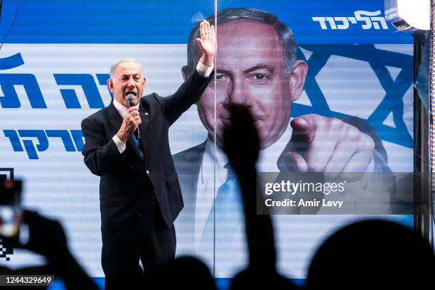 Former Israeli Prime Minister and Likud party leader Benjamin Netanyahu speaks to supporters through inside a modified truck with a side bulletproof...