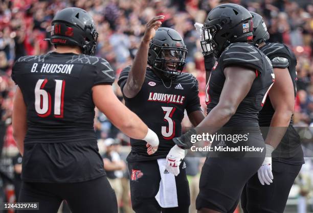 Malik Cunningham of the Louisville Cardinals celebrates with teammates after a touchdown during the first half against the Wake Forest Demon Deacons...