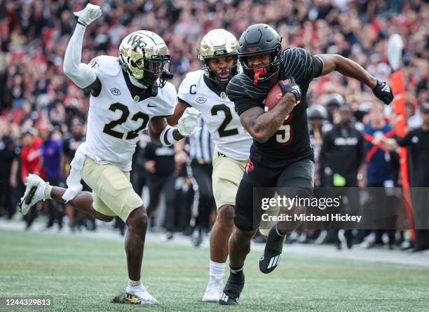 Marshon Ford of the Louisville Cardinals runs the ball as AJ Williams of the Wake Forest Demon Deacons closes in for the tackle during the first half...