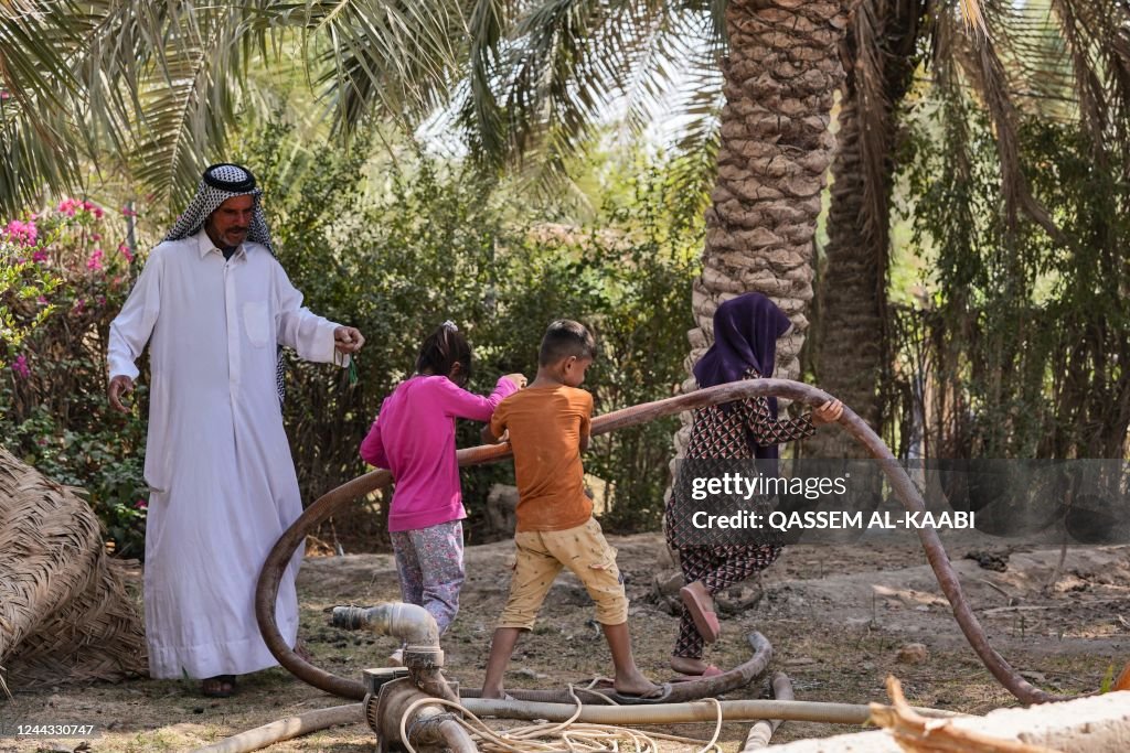 Iraq Farms Rivers Iraqi farmer Jabar al-Fatlawi and his children inspect the water ...