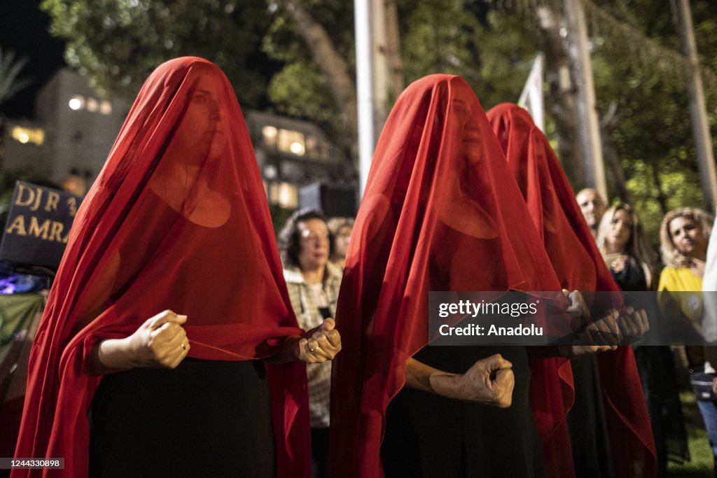 A group of people holding banners and Iranian flags, gather for a ...