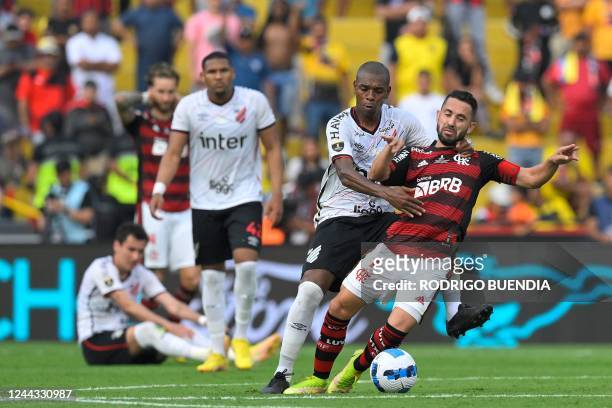 Athletico Paranaense's Brazilian midfielder Fernandinho grab Flamengo's Brazilian midfielder Everton Ribeiro during the Copa Libertadores final...