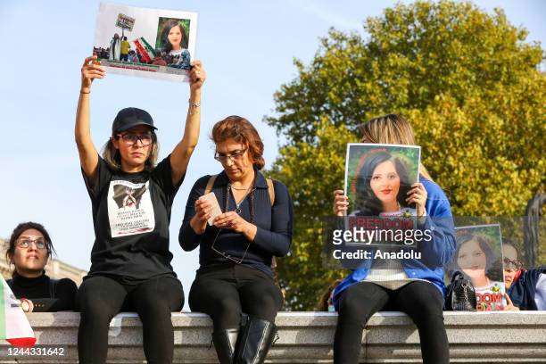 Woman hold placards as hundreds of Iranians demonstrate in Trafalgar Square in London, Britain, October 2022, protesting in solidarity with Iran...