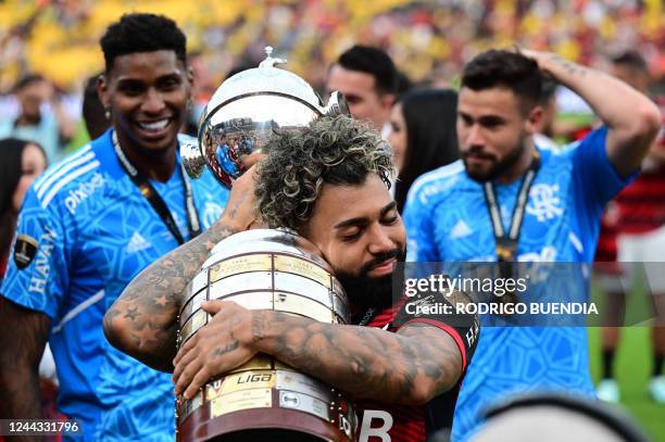 Flamengo's Brazilian forward Gabriel Barbosa celebrates with the trophy after winning the Copa Libertadores final, after the football match between...